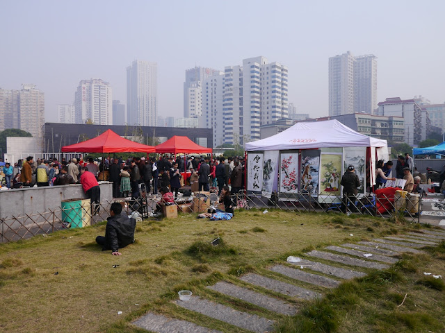 view of an outdoor antique market in Changsha, China, with tall buildings in the background