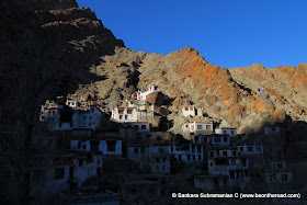 The sun sets over the houses of the monks at Hemis