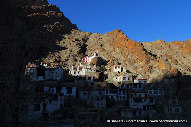 The sun sets over the houses of the monks at Hemis