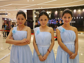 three young women wearing dresses