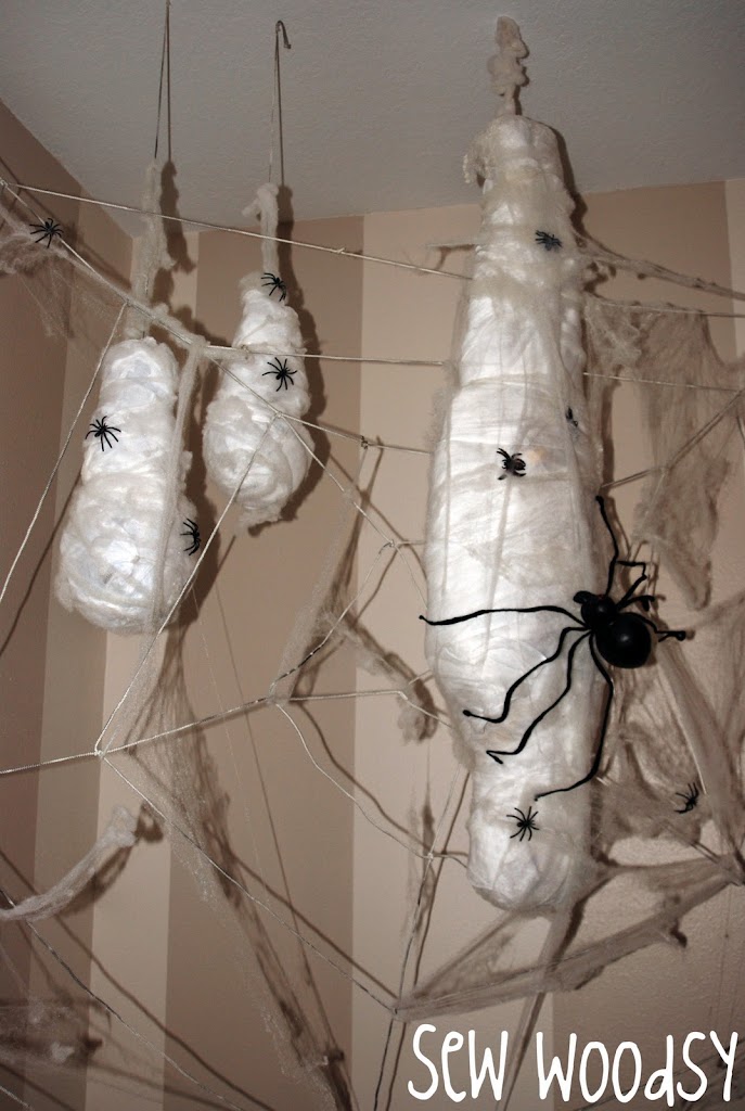 White rope spider web with webbed person and larva sacks.