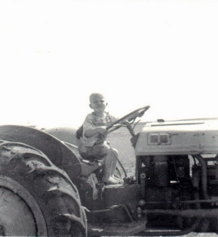 Young Russ Crites learning to drive tractor in Montana