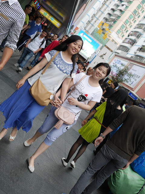 two young women walking holding hands