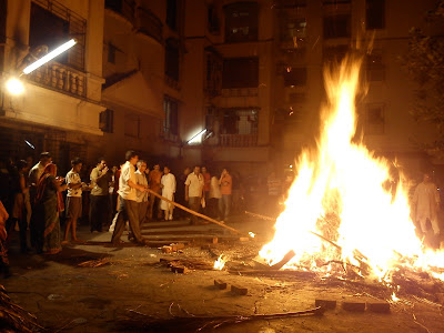 People praying to the Holika Dahan fire during the Holi festival in India