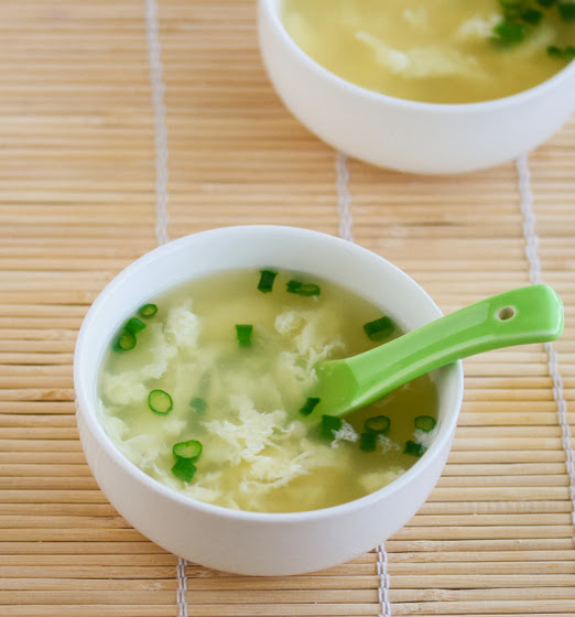 overhead photo of a bowl of Egg Drop Soup with a spoon