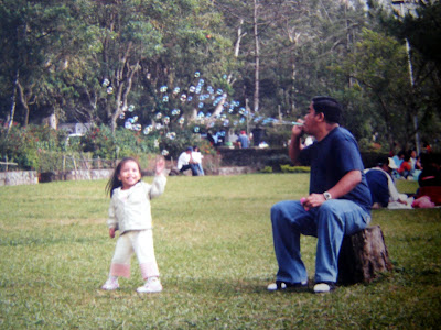 father and child playing bubbles