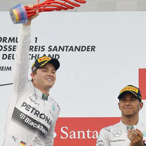 Mercedes-AMG's German driver and race winner Nico Rosberg (L) celebrates with teammate Mercedes-AMG's British driver Lewis Hamilton (R) after winning the German Formula One Grand Prix at the Hockenheimring racing circuit in Hockenheim, southern Germany, on July 20, 2014