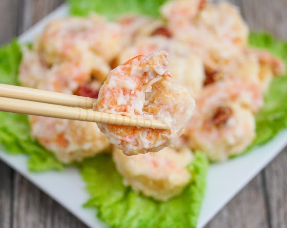 close-up photo of chopsticks holding a shrimp