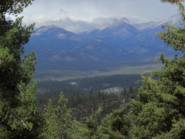 distant bald peaks dressed in cloud