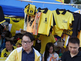 people in front of hanging shirts