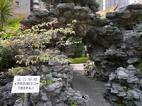 tunnel through an artificial rock formation in a Macau park