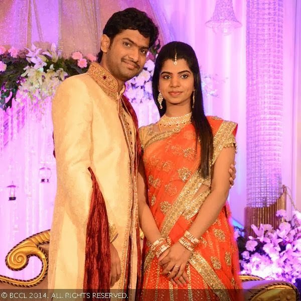 Newlyweds, Abhilash and Elakkiya pose onstage for a photo during their wedding reception party, held at The Leela Palace in Chennai.