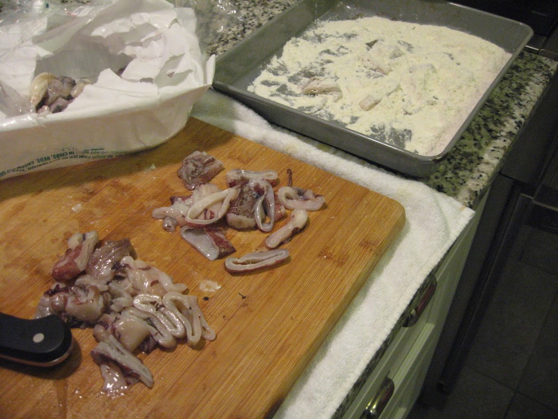 Squid being cut and ready for the seasoned flour 