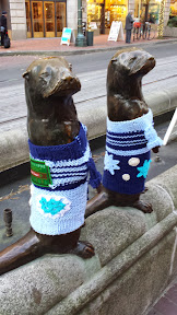 #UglySweaterPDX campaign, 2014: Some of downtown’s most iconic sculptures will don their holiday finery for the season. In the Pioneer District on Southwest Yamhill and Morrison streets (between Fifth and Sixth avenues), you’ll see Animals in Pools, Allow Me (aka “Umbrella man”) and Kvinneakt dressed up in festive ugly sweaters.