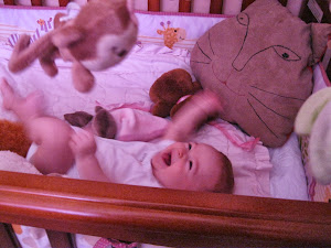 Karina playing in her crib