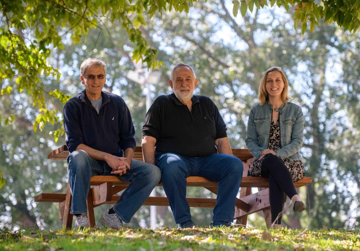 A group of people sitting on a bench

Description automatically generated