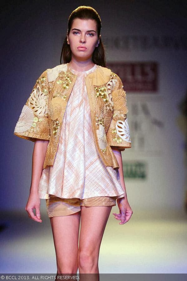 A model showcases a creation by fashion designer Nachiket Barve on Day 1 of Wills Lifestyle India Fashion Week (WIFW) Spring/Summer 2014, held in Delhi.
