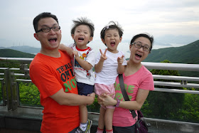 young Hong Kong family making similar faces for a photo