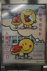 a hamburger holding hands with a large smiley face inside a subway station as the smiley face imagines later eating the hamburger friend outside of the station