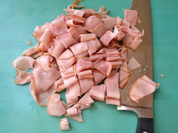 ham sliced into small pieces with knife 
