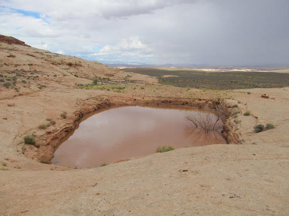 Reservoir that was blasted out of the sandstone, with an earthen dam title=