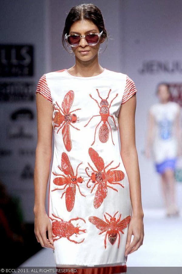 A model showcases a creation by fashion designer Jenjum Gadi on Day 3 of Wills Lifestyle India Fashion Week (WIFW) Spring/Summer 2014, held in Delhi.