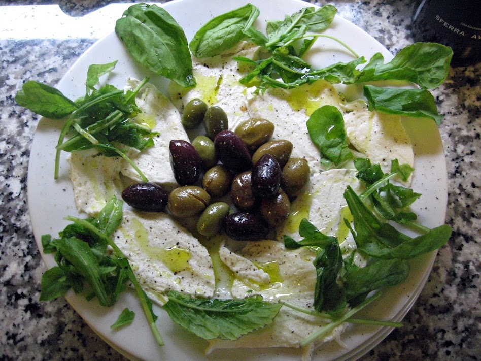 Fresh, whole, cow's, milk Mozzarella with olives and arugula - dressed with extra virgin olive oil, sea salt, and freshly cracked black pepper (the pepper is optional)