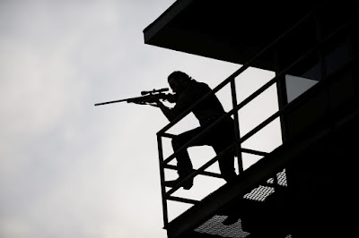 Rick aiming a sniper rifle