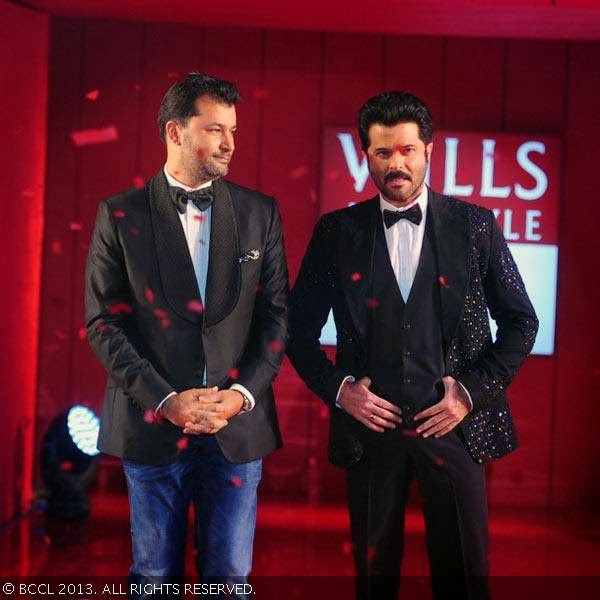 Anil Kapoor walks the ramp with designer Ashish N Soni during the grand finale of the Wills Lifestyle India Fashion Week (WIFW) Spring/Summer 2014, held in Delhi.