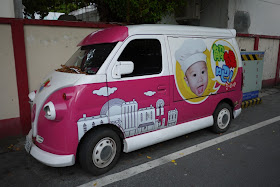 van with large face of a happy baby with a chefs hat