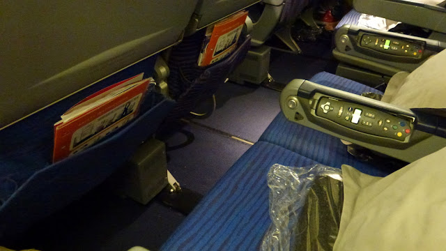 Empty Qantas 747 seats, blue in colour.