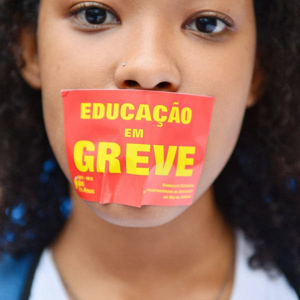 A girl bears a sticker in her mouth reading 'Education on strike' during a teachers protest demanding better working conditions and against police beating, on October 7, 2013 in Rio de Janeiro.