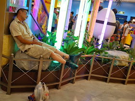 man sleeping at the M&M's World in Shanghai