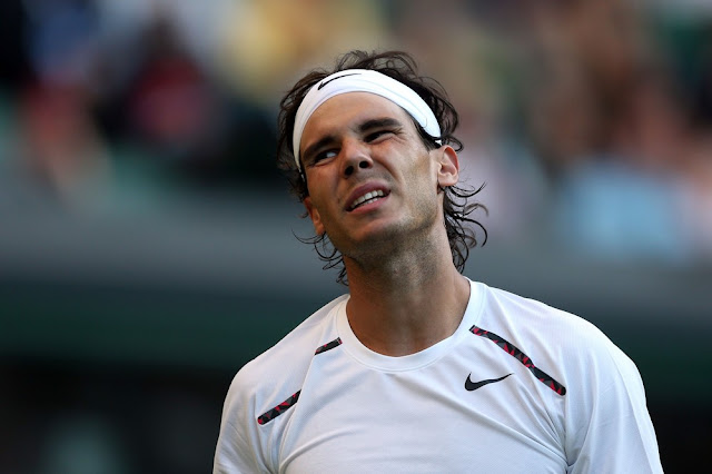 LONDON, ENGLAND - JUNE 28:  Rafael Nadal of Spain reacts during his Gentlemen's Singles second round match against Lukas Rosol of the Czech Republic on day four of the Wimbledon Lawn Tennis Championships at the All England Lawn Tennis and Croquet Club on June 28, 2012 in London, England.  (Photo by Clive Rose/Getty Images)
