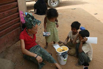 Dog Meets World - kids watching their first personal photo being printed by Ariane Kirtley in Azawak region of Niger