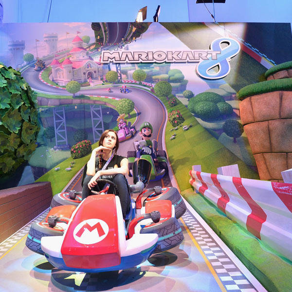 Fans enjoy the Nintendo Mariokart 8 display at the E3 Gaming and Technology Conference at the Los Angeles Convention Center in Los Angeles, California on June 11, 2013.