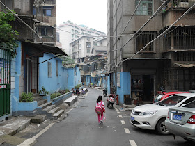 young student walking down an alley