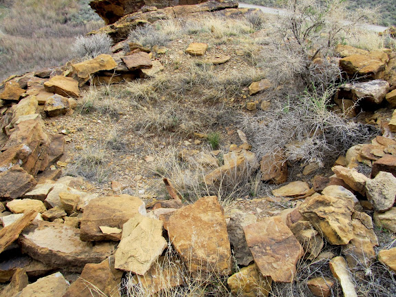 Pit house remains below some granaries