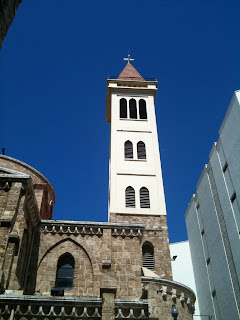a tall white tower with a cross on top