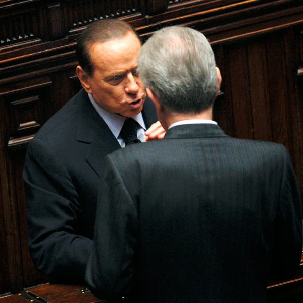 Mario Monti (R) talks with his predecessor Silvio Berlusconi during a vote of confidence at the Lower House of Parliament in Rome.