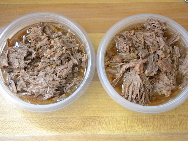 shredded beef in two Tupperware containers 