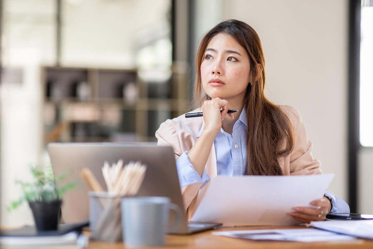 Entrepreneur thinking while holding a document