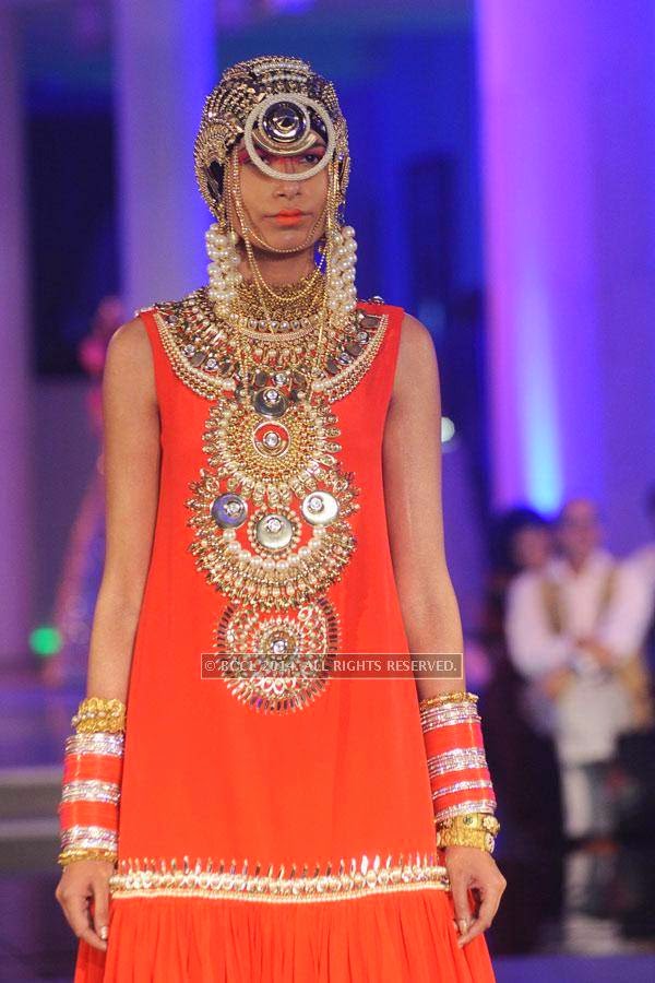 A model showcases a creation by designer Manish Arora on Day 3 of India Couture Week, 2014, held at Taj Palace hotel, New Delhi.