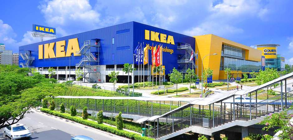 The looming presence of a large blue IKEA building with their bright yellow logo on the front.