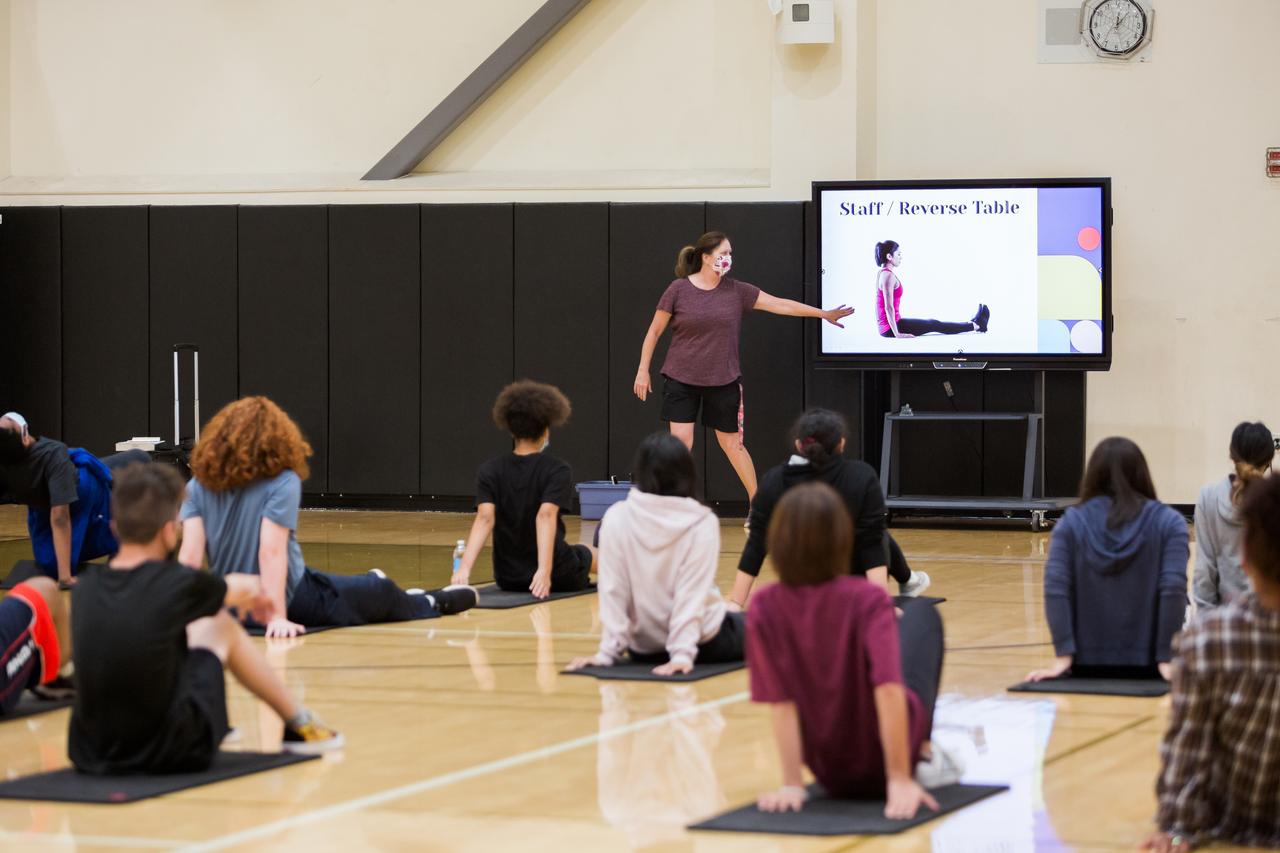 students doing yoga at school using the Promethean ActivPanel interactive display