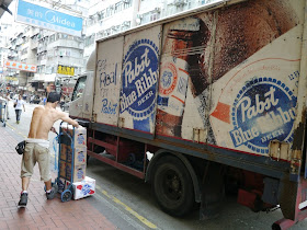 man unloading beer from a Pabst Blue Ribbon truck in Hong Kong
