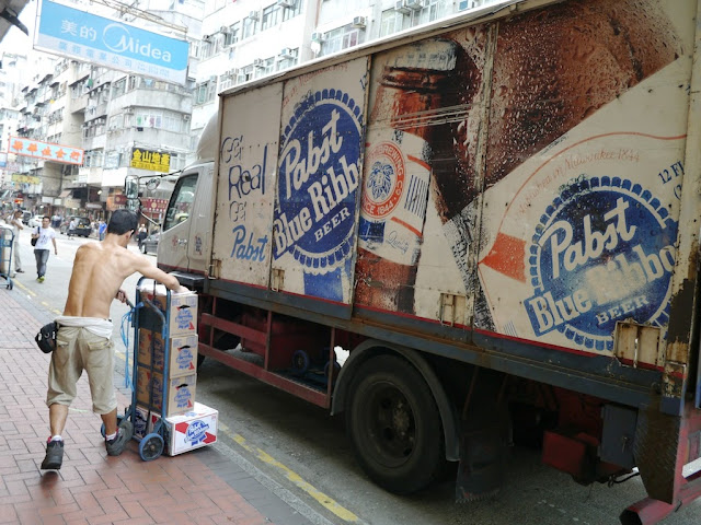man unloading beer from a Pabst Blue Ribbon truck in Hong Kong
