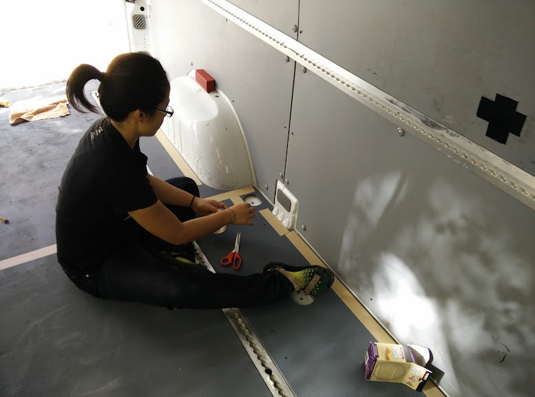 Laying down double sided tape for the Sprinter flooring