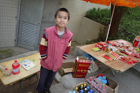 Boy standing near drinks and packaged food for sale at Jingshan Park in Zhuhai