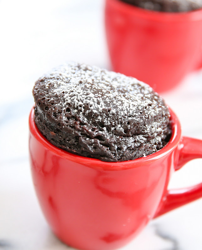photo of a flourless nutella mug cake in a red mug